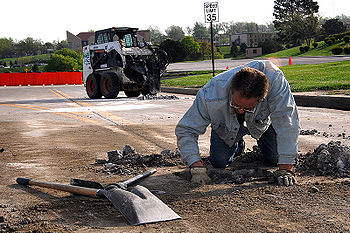 Person repairs a pothole